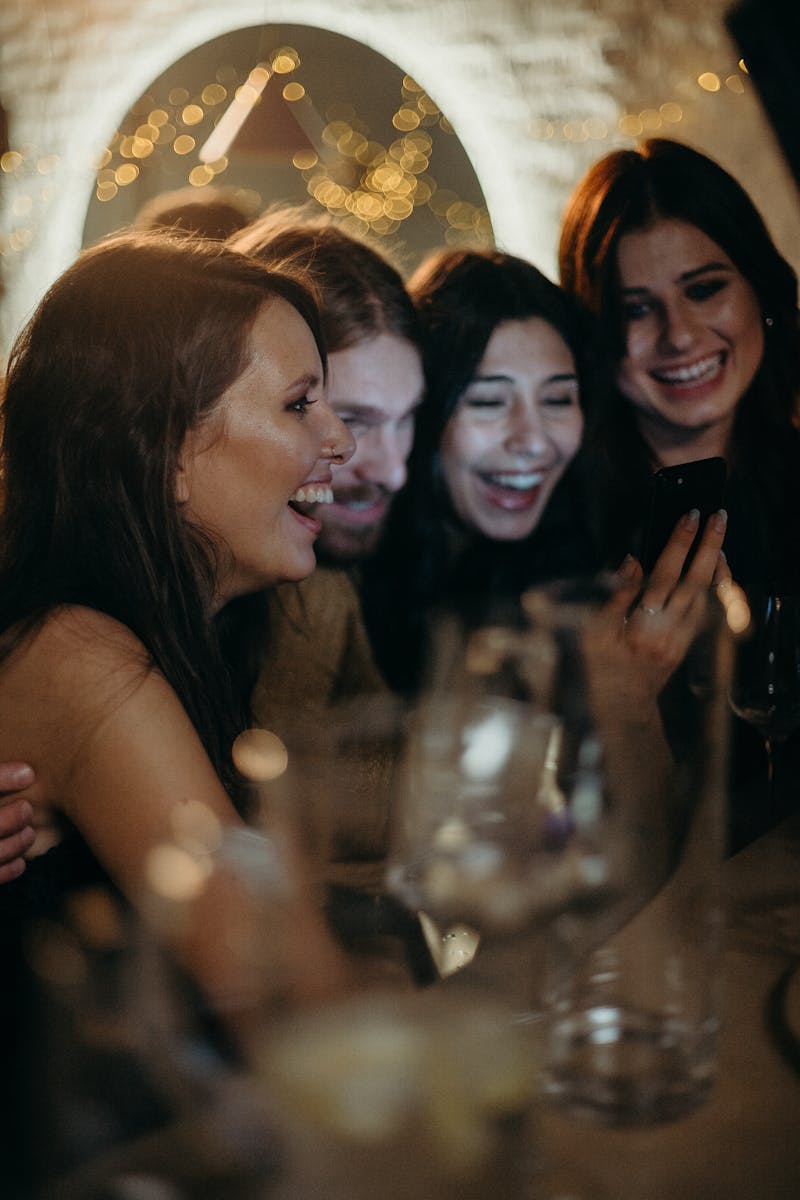 A joyful group of friends enjoying a celebration indoors, sharing laughter and happiness.