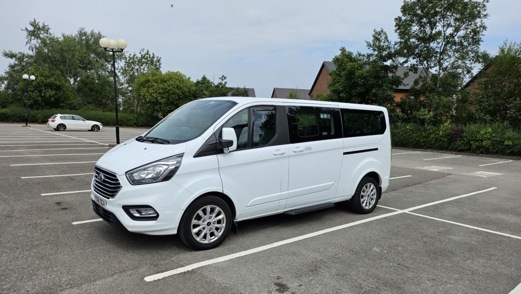 20250725_144724 white minibus in a car park